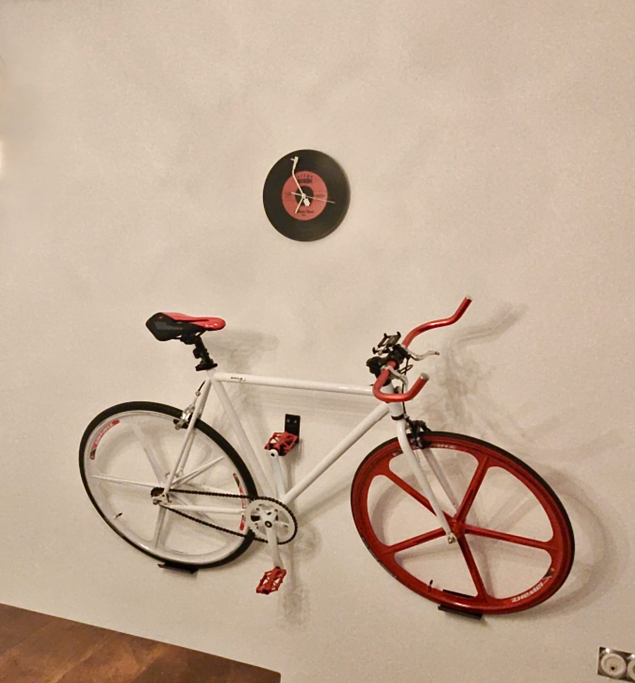 Road bike mounted securely on a living room wall